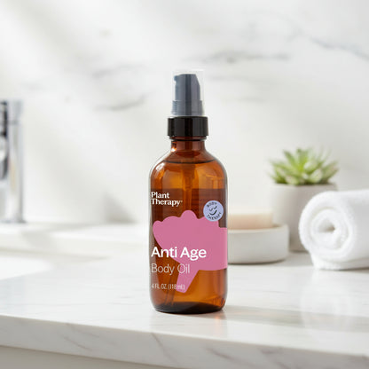 Brown glass bottle of Plant Therapy Anti Age Body Oil on a white background